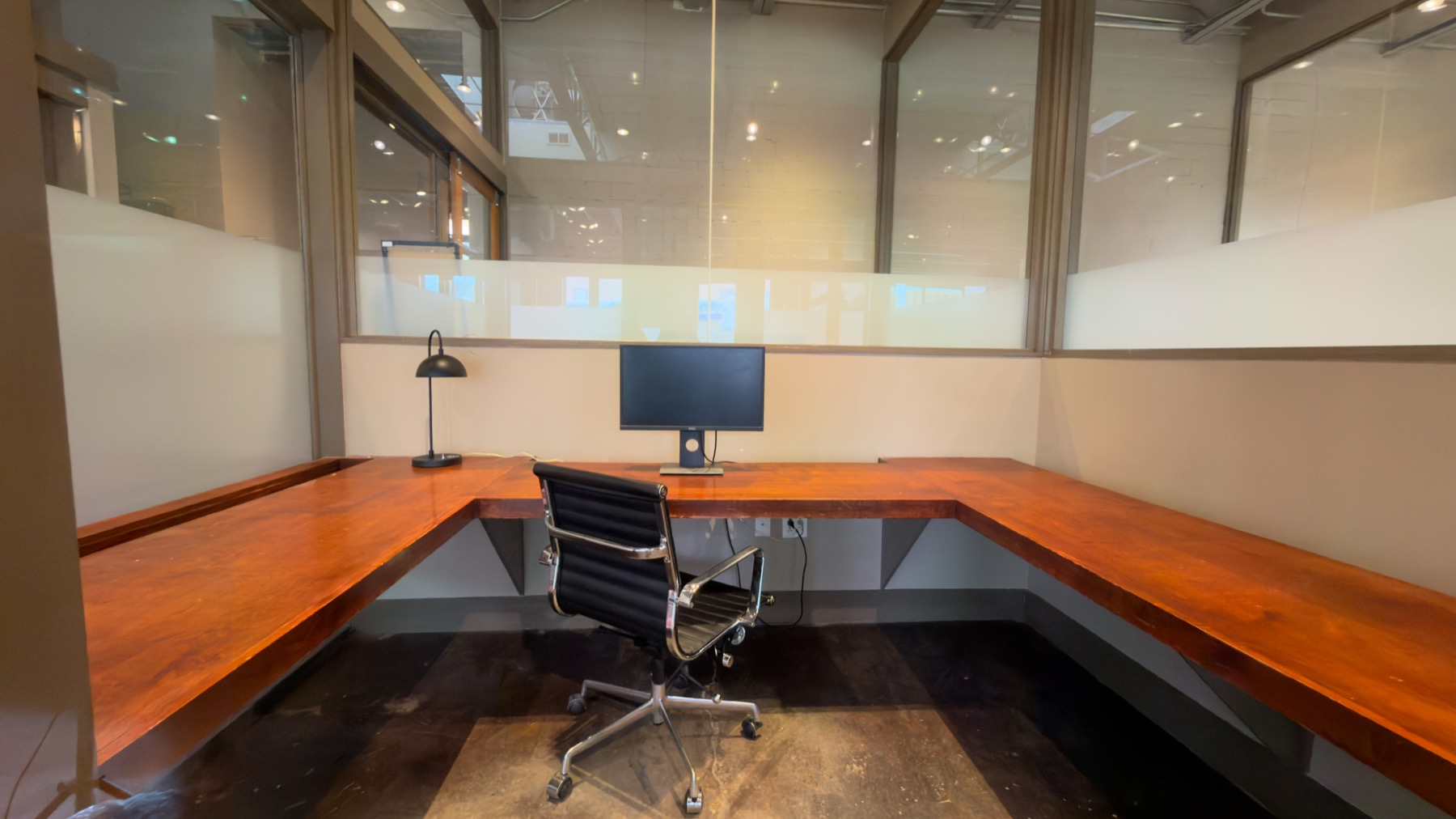 Furnished private office with a wraparound work surface