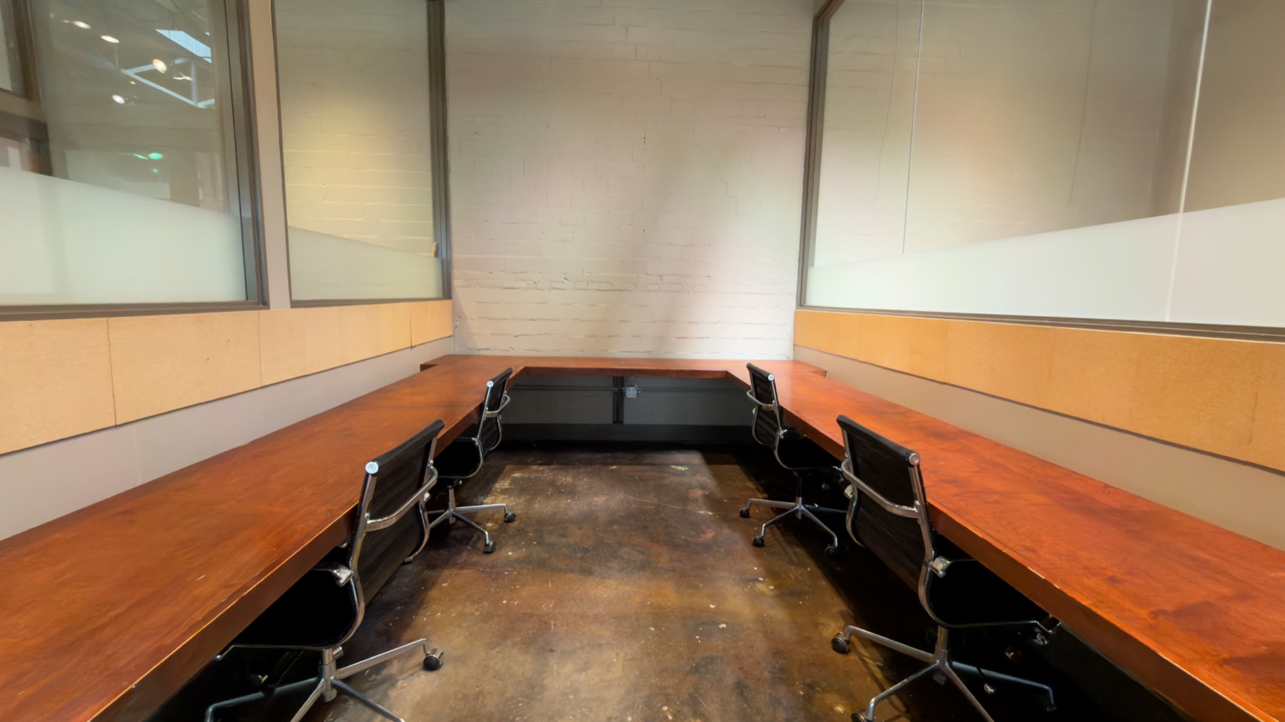 Private office with a long built-in wood desk