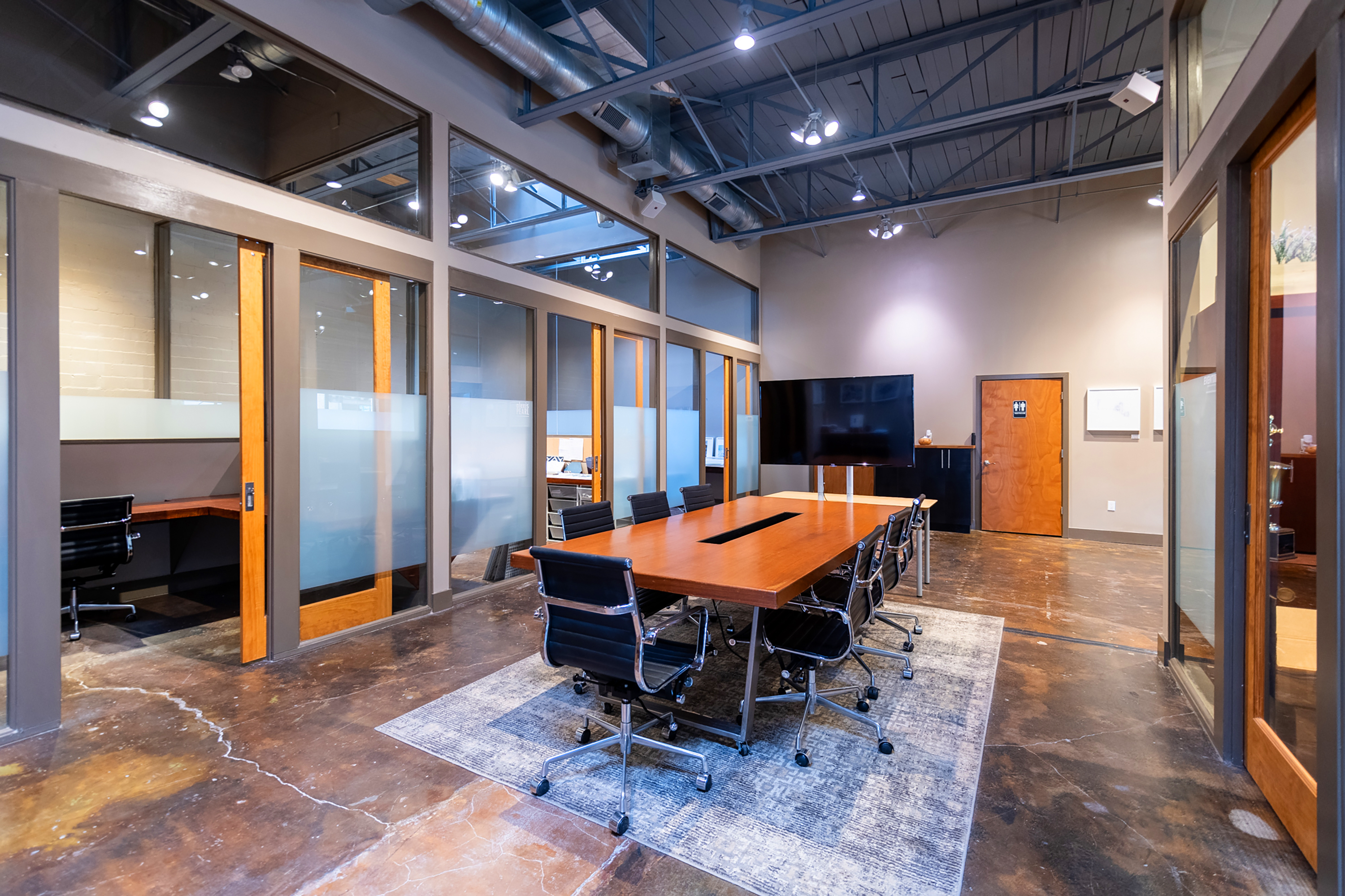 A conference room with a large table inside GeniusDen