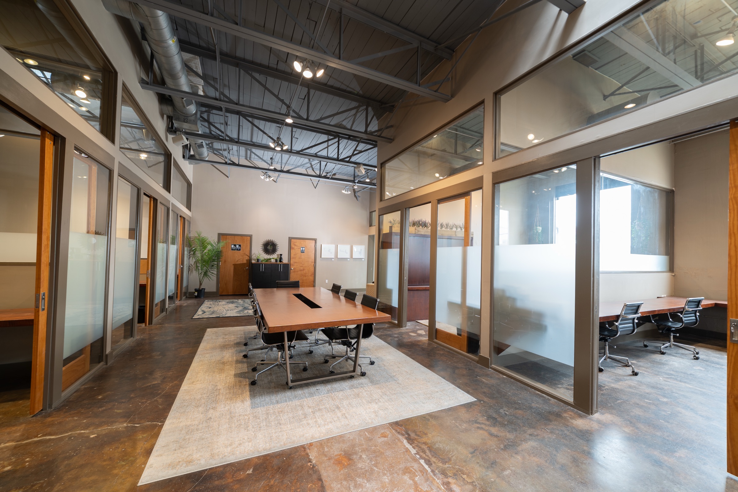 The shared coworking area and long worktables inside GeniusDen