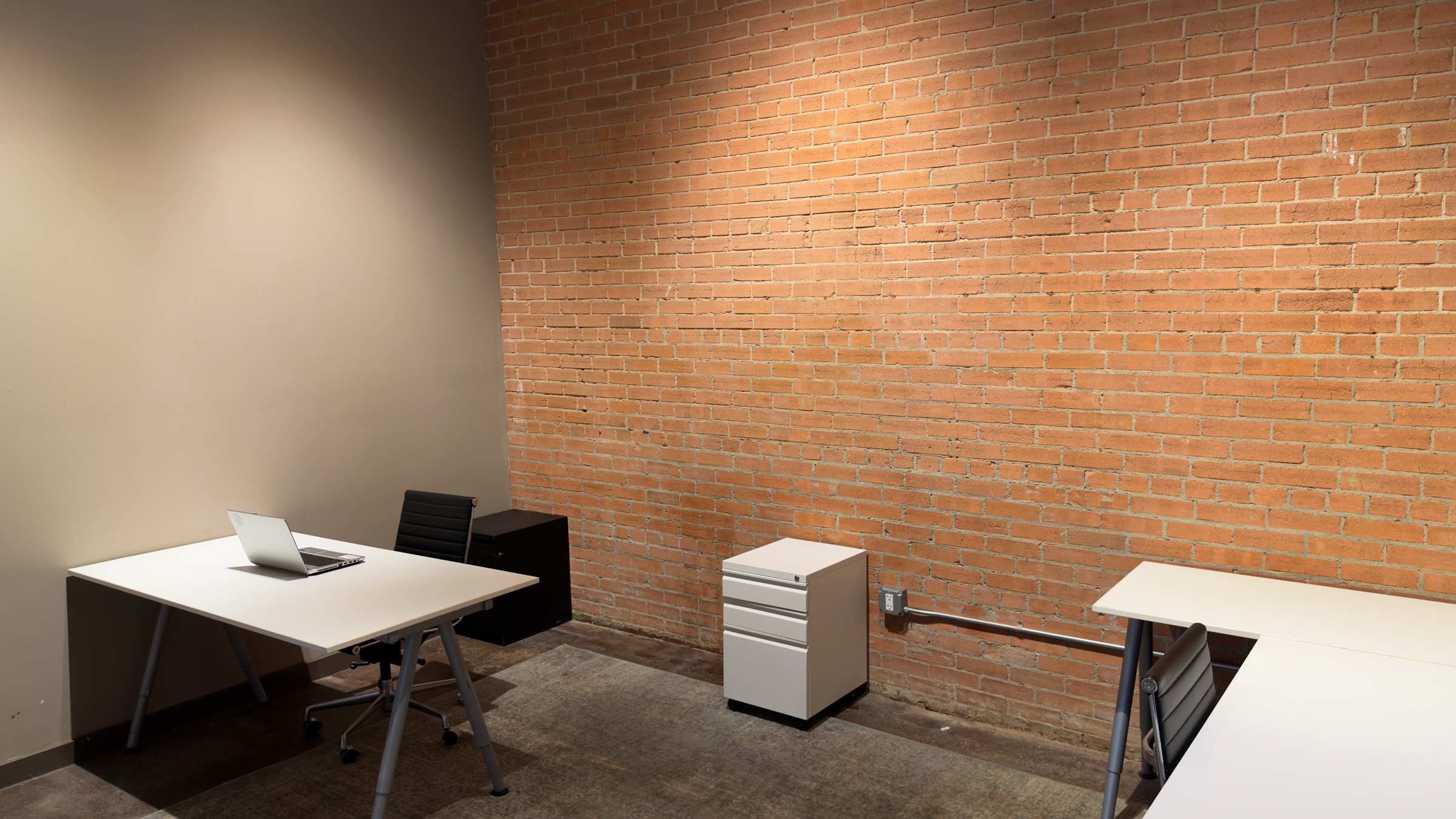 Clean wide view of a current GeniusDen brick office