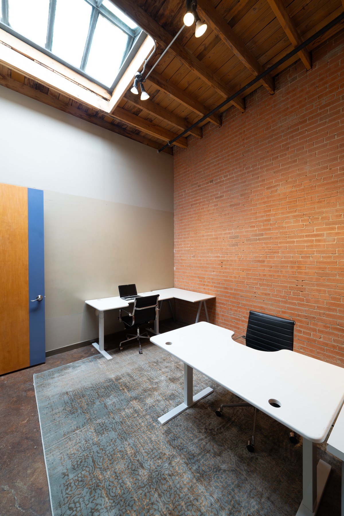 Corridor view of compact GeniusDen offices