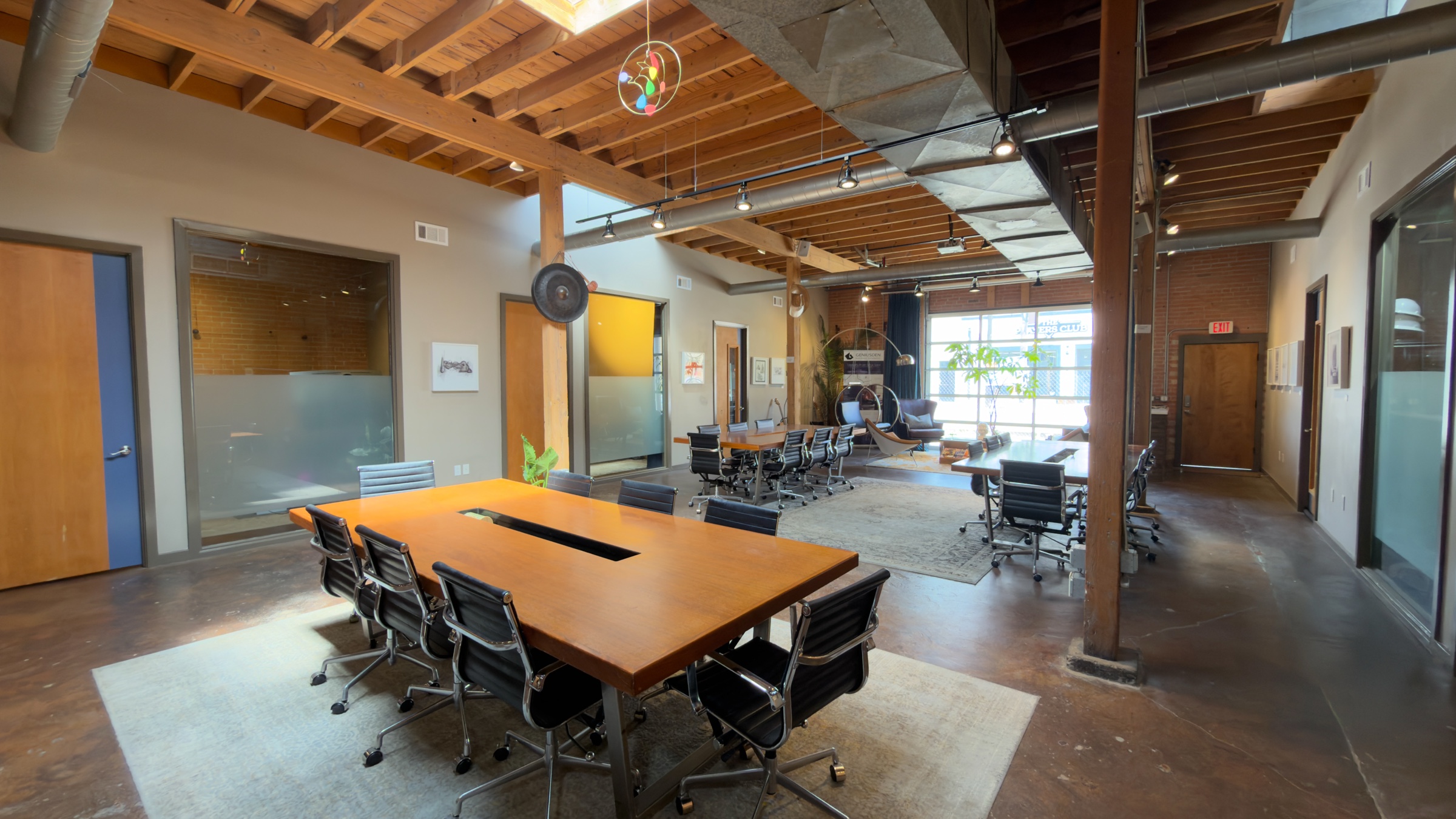 Current GeniusDen shared table with the full room visible beyond